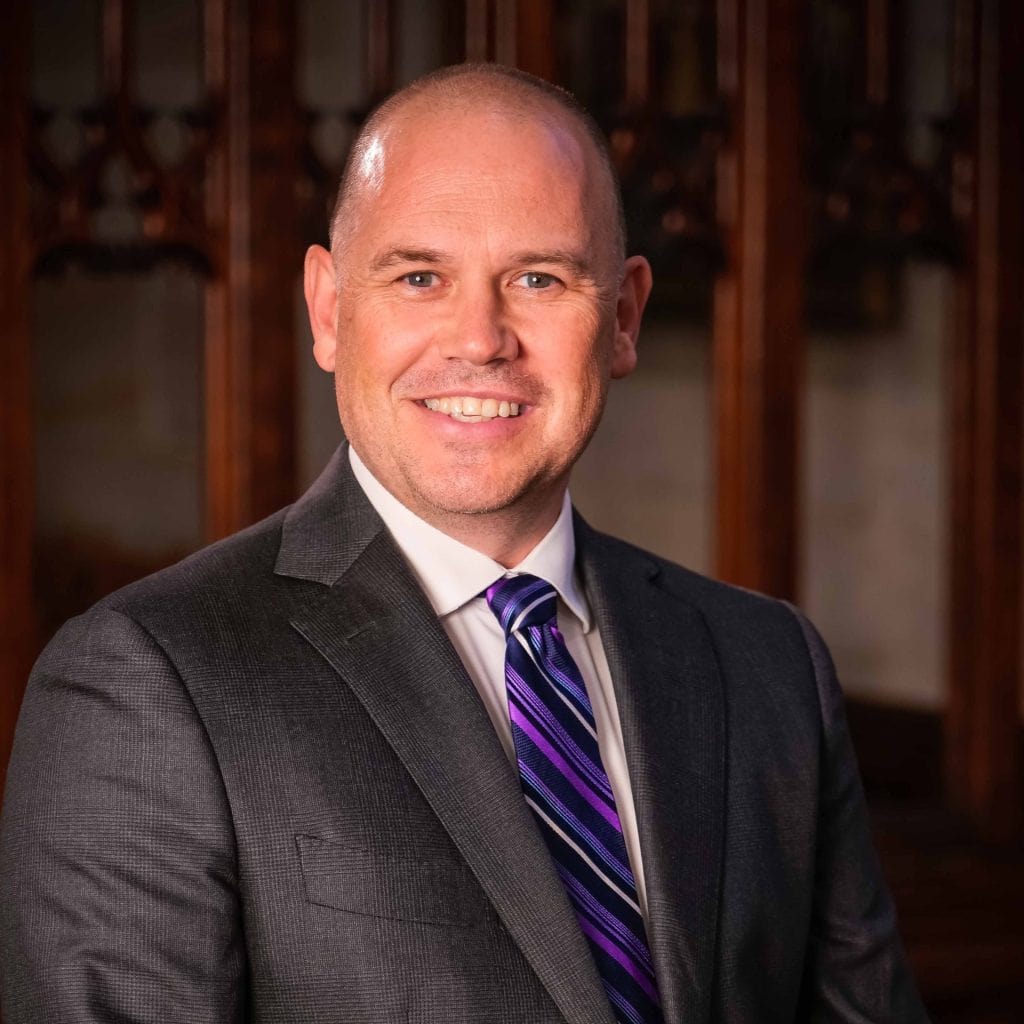 Man smiling at Katoomba Easter Convention in front of wooden interior.
