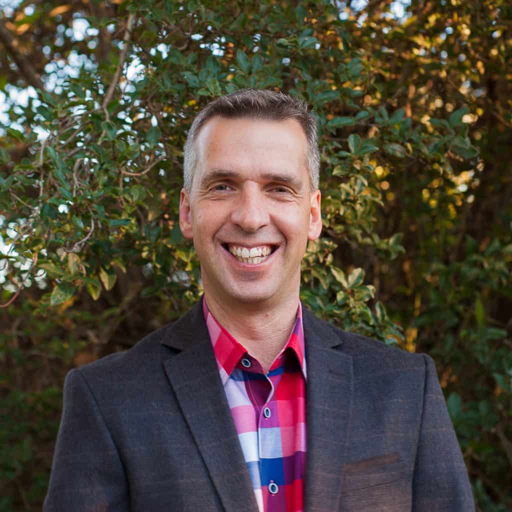 Man smiling at Katoomba Easter Convention in scenic outdoor setting.