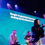 Young woman singing on stage at Katoomba Easter Convention.