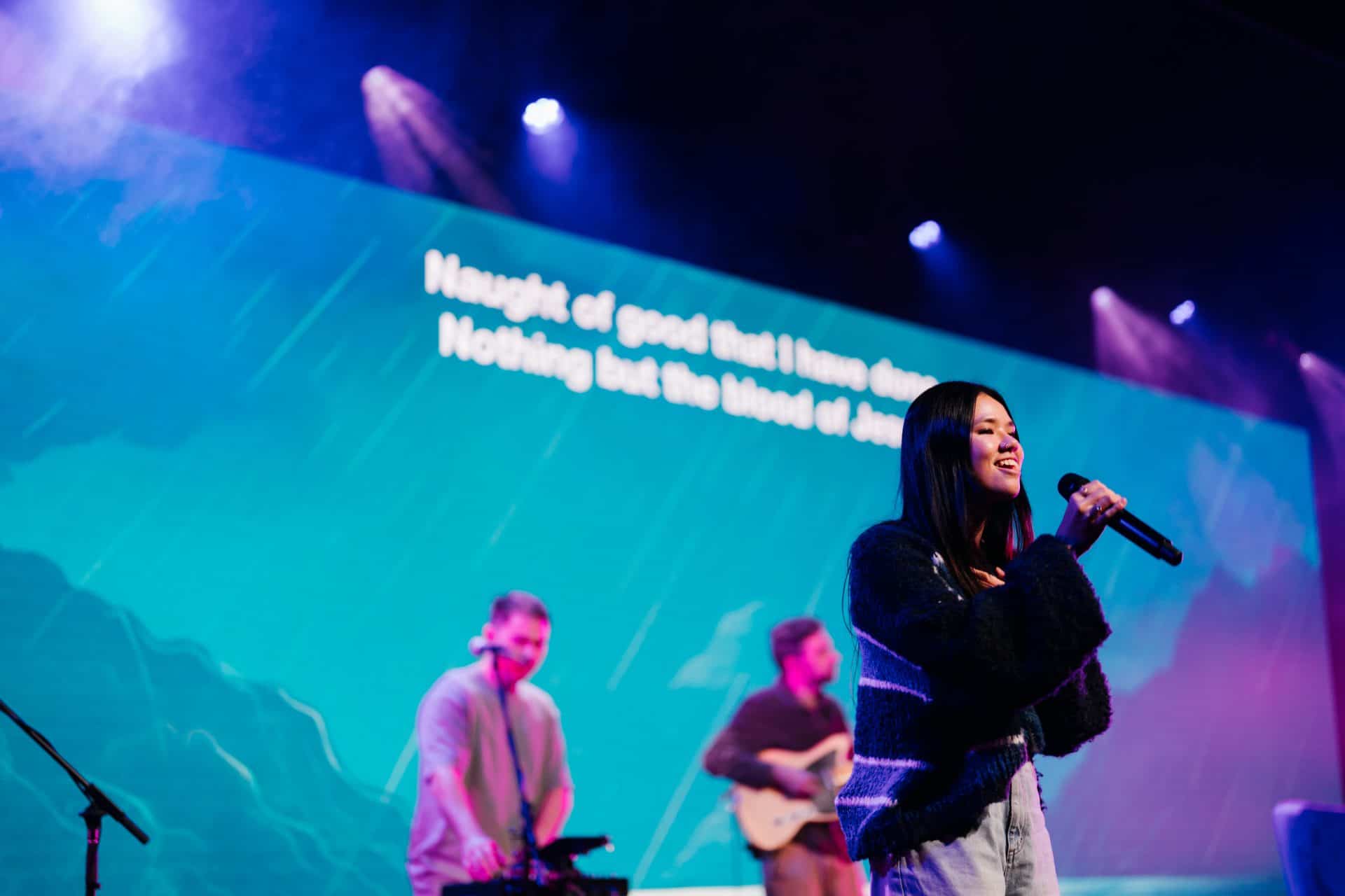 Young woman singing on stage at Katoomba Easter Convention.