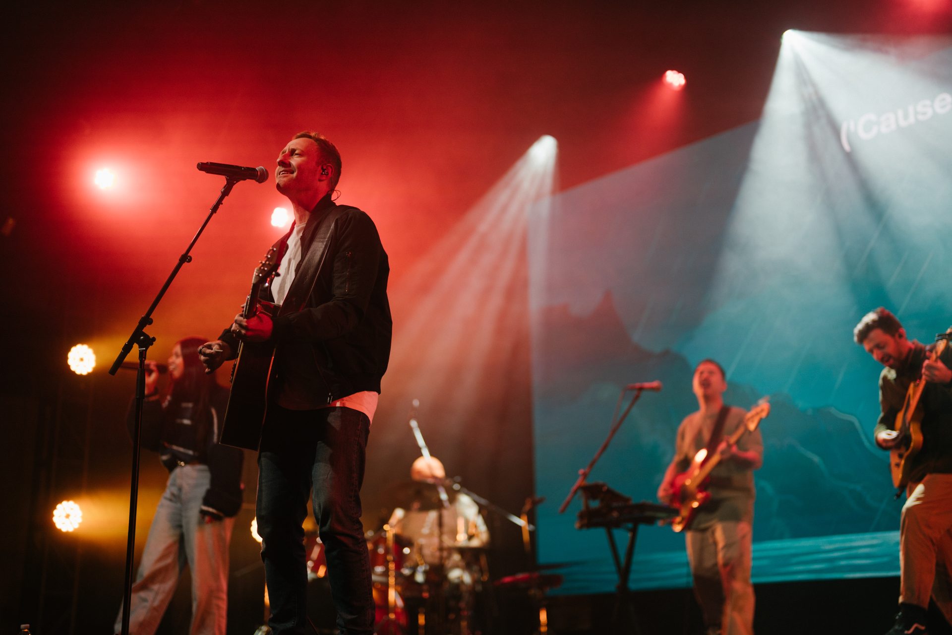 Live band performing at Katoomba Easter Convention with vibrant stage lighting.