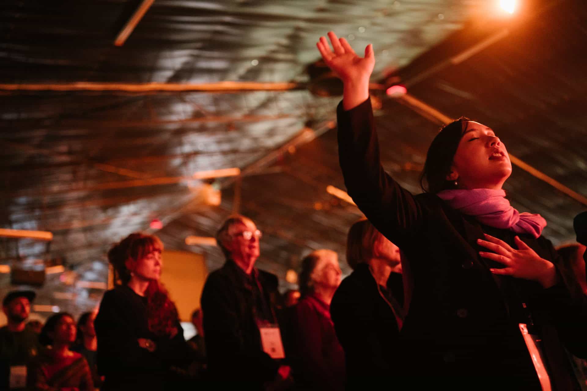 Attendees worshiping at Katoomba Easter Convention in a large tent.